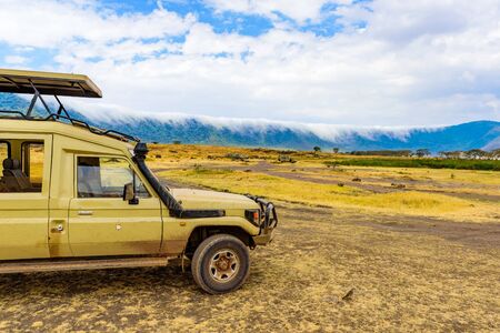 Safari Car in the Ngorongoro crater National Park with the Lake Magadi. Safari Tours in Savannah of Africa. Beautiful landscape scenery in Tanzania, Africの写真素材