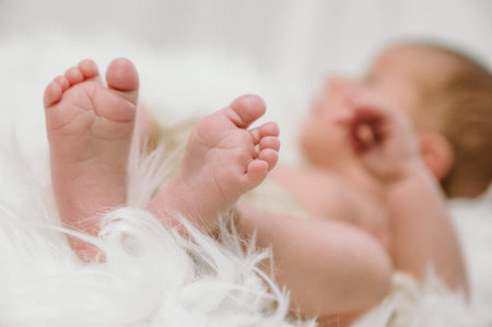 Feet of a newborn baby in the hands of parents. Happy family moment and concept.