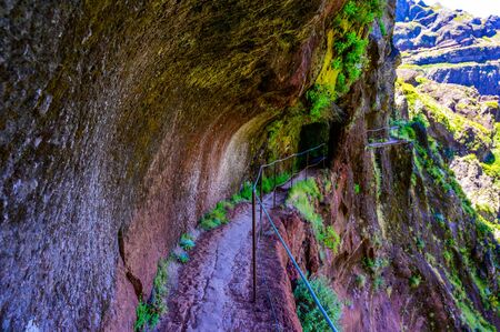 Beautiful hiking trail from Pico do Arieiro to Pico Ruivo, Madeira island. Footpath PR1 - Vereda do Areeiro. On sunny summer day above the clouds. Portugal.の写真素材