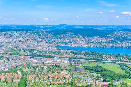 Panoramic view of Zurich lake and Alps from the top of Uetliberg mountain, from the observation platform on tower on Mt. Uetliberg, Switzerland, Europeの写真素材