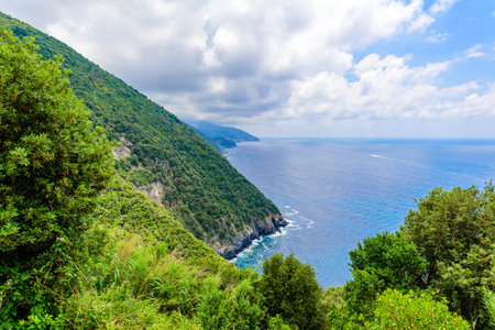 Hiking in beautiful landscape scenery between villages of Cinque Terre National Park at Coast of Italy. Province of La Spezia, Liguria, in the north of Italy - Travel destination for hiking and attraction in Europe.の写真素材