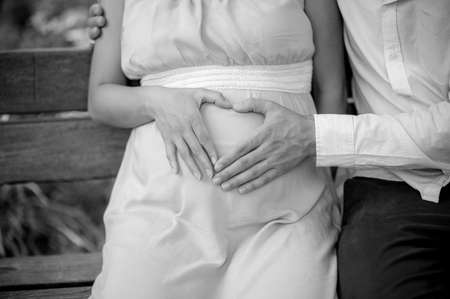 Young pregnant couple expecting a child - Happy Family Moments in nature - Father and Mother togetherの写真素材