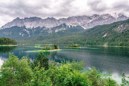 Small islands with pine trees in the middle of Eibsee lake with Zugspitze mountain. Beautiful...