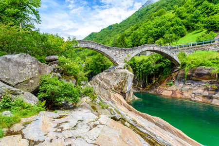 View of Bridge Ponte dei Salti to Verzasca River at Lavertezzo - clear and turquoise water stream and rocks in Ticino - Valle Verzasca - Valley in Tessin - Travel destination in Switzerlandの写真素材