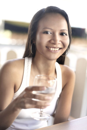 Young Asian Female Holding a Glass of Waterの写真素材