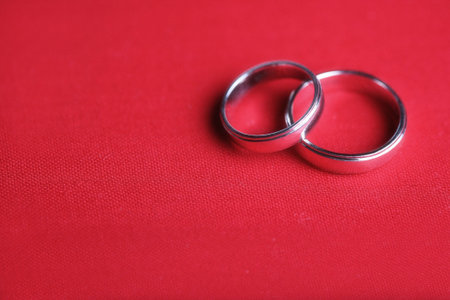 Two Wedding Rings on a Piece of Red Card