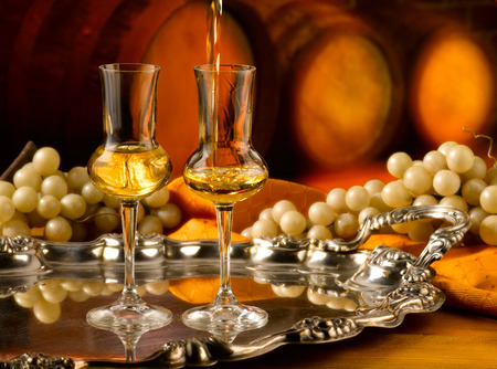 Glass of grappa tasting in the cellarの写真素材
