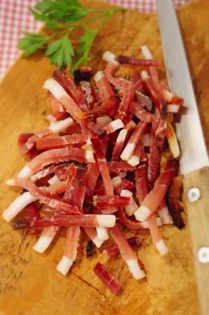Bacon bits on wooden cutting boardの写真素材
