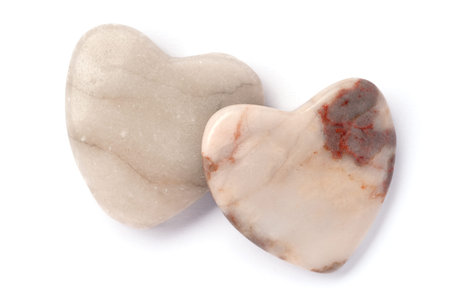 two hearts made of stone isolated over whiteの写真素材