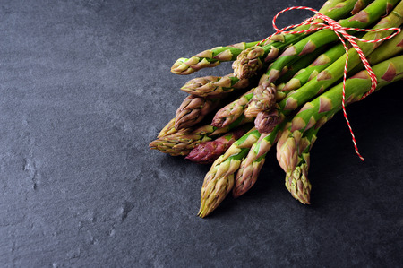 fresh green asparagus over black slater  backgroundの写真素材