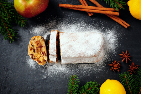 Traditional Christmas Stollen on dark plateの写真素材