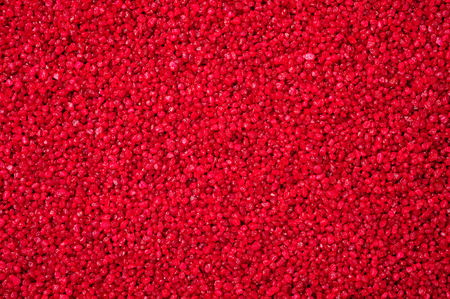 granular texture of red granulat for abstract backgroundの写真素材