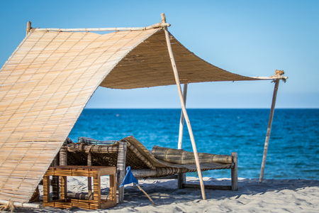 Laying beds in the sand on the beach on the Swahili Coast, Tanzaniaの写真素材