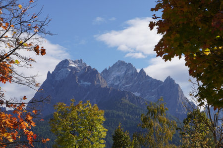 Autumn alpine landscape with snow-capped mountain peaks in the backgroundの写真素材