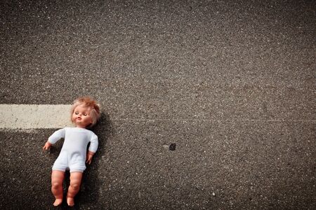 doll leave on a highway lane after car accidentの写真素材