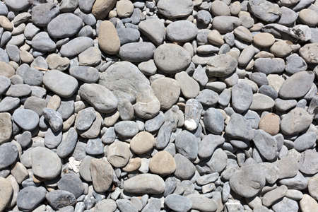 background of rond rocks on the beachの写真素材