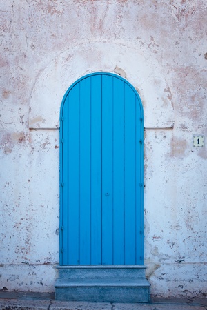 Blue door of a greek architecture style home in south of italyの写真素材