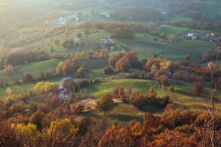 high view of hill and little village in italian mountainsの写真素材