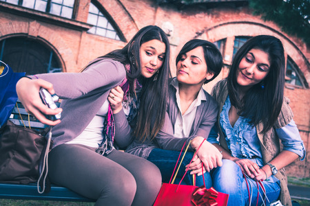 group of girls make herself a phto with a digital cameraの写真素材