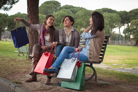 group of girls make shopping with coloured bagsの写真素材