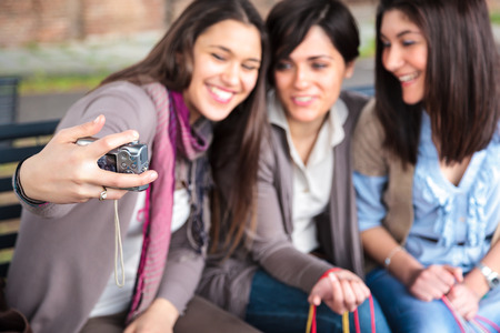 group of girls make herself a phto with a digital cameraの写真素材