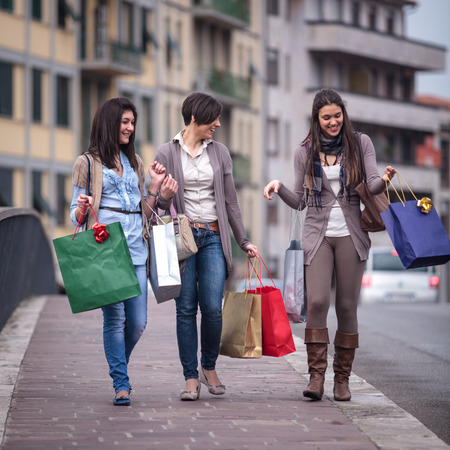 group of girls make shopping with colored bagsの写真素材
