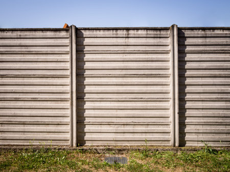 concrete wall of industrial background with sky and grassの写真素材
