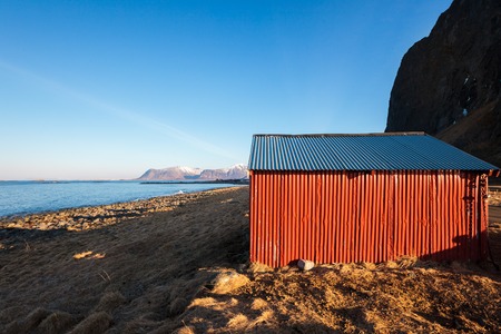 Red wooden coastal houses in Norwegian fishing villageの写真素材