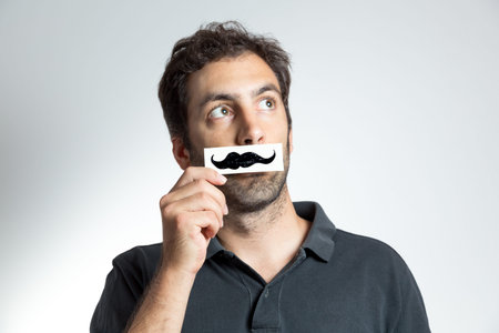 frontal portrait of young man with fake moustaches