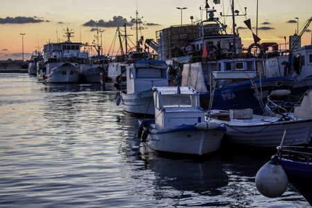 Fishing boats at sunsetの写真素材