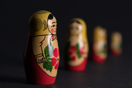 Four Russian nested dolls standing in formation with three of them being blurred.の写真素材