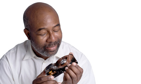 African American Male technician hand holding and looking on  computer hard drive with screwdriver5