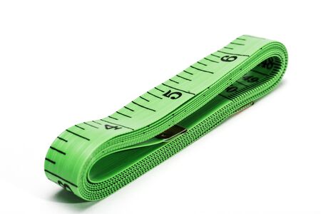 Folded green Measuring tape isolated on white background. Used for sewing or measuring for diet.の写真素材