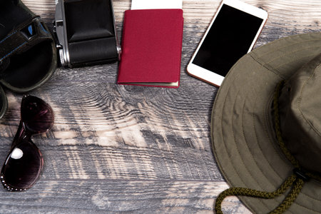 Traveler's accessories, Sunglasses, Sandals, camera, Money, Hat, Phone. Overhead view of  Essential...
