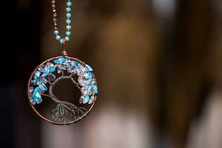 Copper Pendant necklace with Aquamarine Stones. Tree of life on dark backgroundの写真素材
