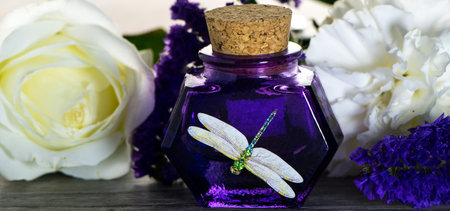 Vintage Purple Glass  Bottles with cork lid and dragonfly picture on wooden boards. Glass Container...