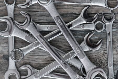 Pile Of Wrenches on Wood Floor. Silver and Chrome tools. Top Viewの写真素材