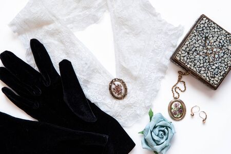 Velvet Gloves with lace collar, jewelry, box and paper rose.  Vintage Still life. Old Fashion Concept from top viewの写真素材