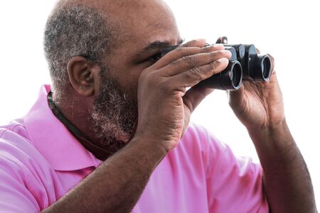African American man looking through binoculars on white backgroundの写真素材