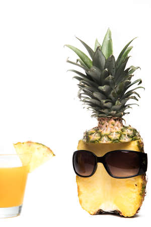 Pineapple half with dark sunglasses and glass on white background for summer holidayfunny  and vacation conceptの写真素材