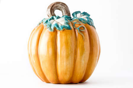 Decorative orange ceramic pumpkin isolated against white background. Thanksgiving conceptの写真素材