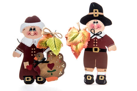 Wooden pilgrim man and woman figurines for Thanksgiving holiday agaist white backgroundの写真素材