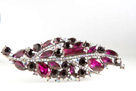 Purple jewelry brooch with white and black stones isolated on white backgroundの写真素材
