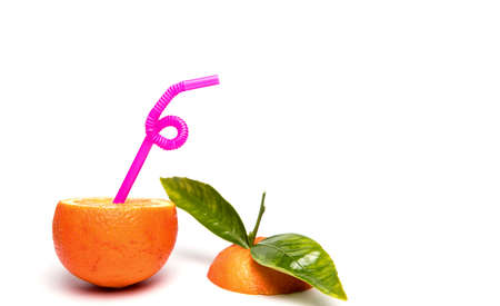 Straw in cut orange fruit isolated on white background with copy spaceの写真素材