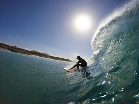 surfer in the tube of a wave