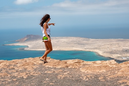 girl together with her mascot on the summit of the coast of Lanzaroteの写真素材