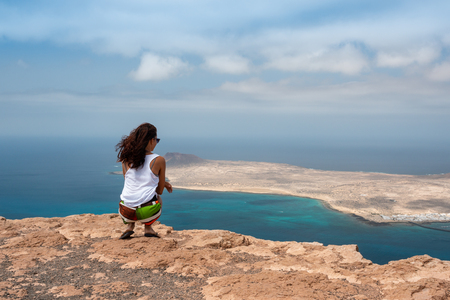 girl together with her mascot on the summit of the coast of Lanzaroteの写真素材