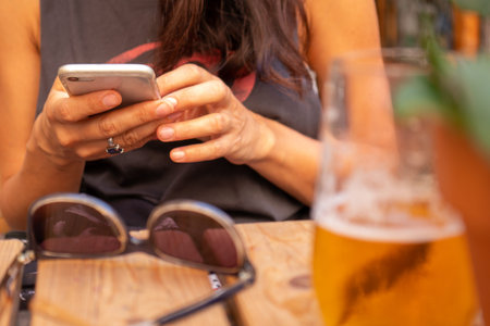 moment of relaxation with smartphone and beer