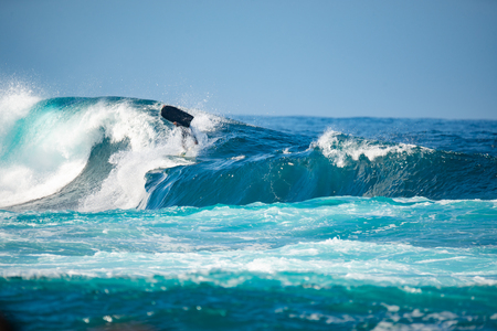 surfer in action on a big wave, lanzarote - canary islandsの写真素材