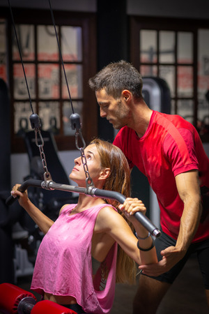 girl in training assisted by personal trainerの写真素材